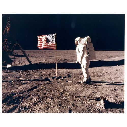Buzz Aldrin with the flag of the United States