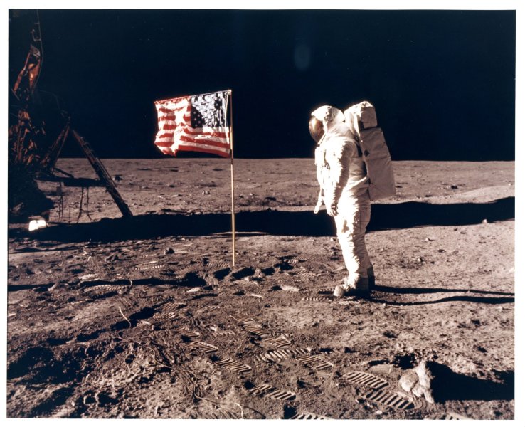 Buzz Aldrin with the flag of the United States